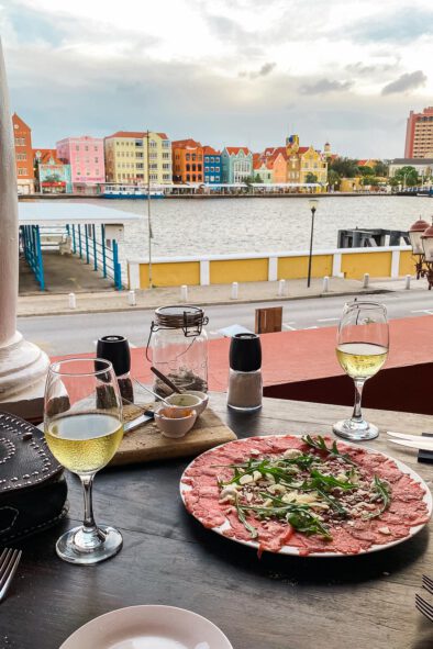 Eating carpaccio and drinking wine overlooking the skyline of Willemstad