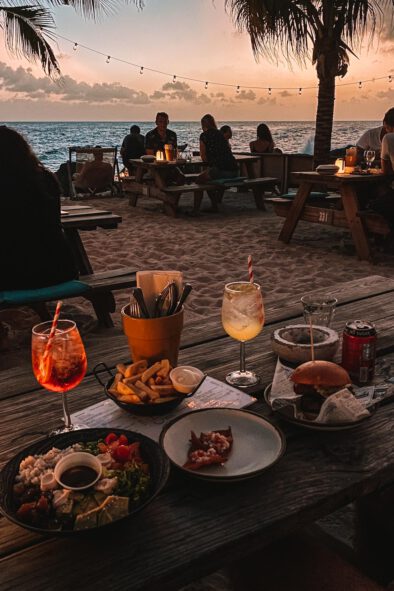 Uit eten op het strand tijdens zonsondergang