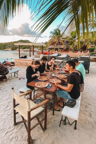 Eating pizza at a restaurant on the beach